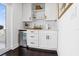 Modern bar area offers storage cabinets, drawers, shelving, mini-fridge, white subway tile, and elegant finishes at 820 2Nd N Ave, St Petersburg, FL 33701