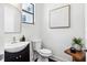 Stylish half bath with a modern sink, toilet, and decorative wall art at 820 2Nd N Ave, St Petersburg, FL 33701