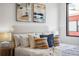 Bright bedroom showcasing a comfortable bed with stylish throw pillows next to a small bedside table at 820 2Nd N Ave, St Petersburg, FL 33701