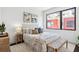 Bright bedroom featuring a comfortable bed with stylish throw pillows and lots of natural light from a large window at 820 2Nd N Ave, St Petersburg, FL 33701
