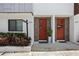 Inviting townhome entrance with vibrant door and lush landscaping at 820 2Nd N Ave, St Petersburg, FL 33701