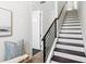 Elegant stairway with dark wood steps, white risers, and modern railing leading to the upper level at 820 2Nd N Ave, St Petersburg, FL 33701