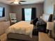 Cozy bedroom with a ceiling fan, large bed, dresser and a full length mirror at 821 Lucent Sands Ct, Brandon, FL 33511