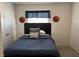 Bedroom with cozy atmosphere featuring a bed with blue bedding and basketball themed decor at 821 Lucent Sands Ct, Brandon, FL 33511