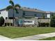 Welcoming entrance to The Retreat, featuring a stone sign with lush landscaping and a modern building facade at 821 Lucent Sands Ct, Brandon, FL 33511
