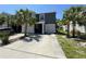 Two-story home with a well-manicured front yard, palm trees, and a convenient two-car garage at 821 Lucent Sands Ct, Brandon, FL 33511