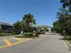 Secure gated community entrance with manicured landscaping, palm trees, and elegant black fencing for privacy at 821 Lucent Sands Ct, Brandon, FL 33511