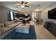 Well-lit living area with plush furniture, a large TV, and an open connection to the modern kitchen at 821 Lucent Sands Ct, Brandon, FL 33511
