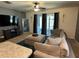 Comfortable living room featuring a plush sofa, a large TV, and seamless access to the outdoors at 821 Lucent Sands Ct, Brandon, FL 33511