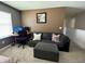 Comfortable living room featuring a gray sofa, ottoman, carpet and a workspace for work or study at 821 Lucent Sands Ct, Brandon, FL 33511