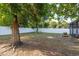 Sprawling fenced-in backyard with mature trees, patio and play area at 8523 N Newport Ave, Tampa, FL 33604