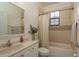 Well-lit bathroom features a shower-tub combo with mosaic tile accents and a vanity at 8523 N Newport Ave, Tampa, FL 33604
