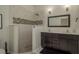 Modern bathroom with dual sinks, walk-in shower, and stylish tile accents at 8523 N Newport Ave, Tampa, FL 33604
