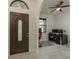 Inviting foyer with elegant front door and tiled floor, leading to a functional office space at 8523 N Newport Ave, Tampa, FL 33604