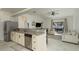 Open-concept kitchen flows into living area with stainless steel appliances and granite countertops at 8523 N Newport Ave, Tampa, FL 33604