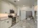 Bright kitchen featuring stainless steel appliances and granite countertops with ample cabinet space at 8523 N Newport Ave, Tampa, FL 33604