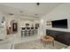 Open living area featuring kitchen, seating at the breakfast bar, and neutral decor at 8523 N Newport Ave, Tampa, FL 33604