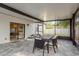 Enclosed patio features a dining table, chairs, tiled floor, and backyard at 8523 N Newport Ave, Tampa, FL 33604