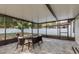 Enclosed patio features a dining table, chairs, and backyard view at 8523 N Newport Ave, Tampa, FL 33604