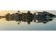 Houses lining the waterfront, with reflections off the calm water, creating a picturesque and serene scene at 861 180Th E Ave, Redington Shores, FL 33708