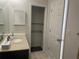 Granite vanity top, ample storage, open closet, and neutral tiles offers clean and practical bathroom at 8665 55Th N St, Pinellas Park, FL 33782