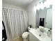 Bathroom featuring modern vanity, patterned shower curtain, and neutral finishes at 8665 55Th N St, Pinellas Park, FL 33782