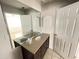 Bathroom featuring dark cabinets, granite countertop, and large mirror at 8665 55Th N St, Pinellas Park, FL 33782