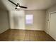 Cozy bedroom with ceiling fan, neutral walls, and tile flooring at 8665 55Th N St, Pinellas Park, FL 33782