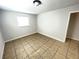 Bright, freshly painted bedroom featuring tiled floors and a window to let in natural light at 8665 55Th N St, Pinellas Park, FL 33782
