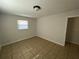 Clean bedroom with tile flooring, neutral walls, and natural light at 8665 55Th N St, Pinellas Park, FL 33782