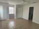 Neutral bedroom with tiled floor, two closets, and a ceiling fan providing comfortable and stylish living space at 8665 55Th N St, Pinellas Park, FL 33782
