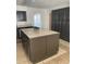 Spacious kitchen island with tile countertop and dark cabinetry, ideal for meal preparation and storage at 8665 55Th N St, Pinellas Park, FL 33782