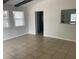 Spacious living room with tile flooring, beam ceiling and natural light at 8665 55Th N St, Pinellas Park, FL 33782