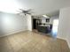 Open living room and kitchen area with tile floors and modern ceiling fan at 8665 55Th N St, Pinellas Park, FL 33782