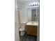 Bright bathroom features a clean, well-lit vanity and a classic toilet at 8708 Cobbler Pl, Tampa, FL 33615