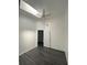 Bright bedroom with a ceiling fan, skylight, and dark gray laminate flooring at 8708 Cobbler Pl, Tampa, FL 33615
