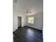 Bedroom features dark gray laminate flooring, a closet, and one window at 8708 Cobbler Pl, Tampa, FL 33615