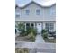 Inviting townhouse with a well-manicured lawn and a classic white front door at 8708 Cobbler Pl, Tampa, FL 33615