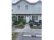 Charming townhouse featuring neutral siding, brick accents, and a well-maintained front garden at 8708 Cobbler Pl, Tampa, FL 33615