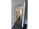 Clean hallway with consistent wood-look flooring and a storage closet at 8708 Cobbler Pl, Tampa, FL 33615
