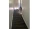 Hallway with neutral paint and dark gray laminate flooring leading to other rooms at 8708 Cobbler Pl, Tampa, FL 33615