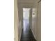Hallway with sleek flooring leads to a bright room with a ceiling fan at 8708 Cobbler Pl, Tampa, FL 33615