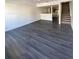 Open living space with modern flooring and an adjacent staircase at 8708 Cobbler Pl, Tampa, FL 33615