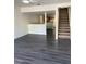 Bright living room with stylish flooring, stairs, and an open view to the kitchen at 8708 Cobbler Pl, Tampa, FL 33615