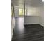 Bright living room with stylish flooring, a front door view, and white walls at 8708 Cobbler Pl, Tampa, FL 33615