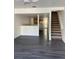 Open living area featuring modern flooring and an open staircase at 8708 Cobbler Pl, Tampa, FL 33615