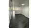 Bright living room with stylish flooring, a front door view, and white walls at 8708 Cobbler Pl, Tampa, FL 33615