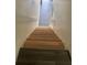 Wooden staircase with a white handrail featuring dark gray laminate flooring at 8708 Cobbler Pl, Tampa, FL 33615