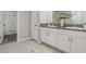 Bathroom featuring double sinks, granite counters, and neutral wall paint at 8812 Parsons Hill Blvd, Wesley Chapel, FL 33545