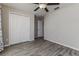 Bedroom featuring wood-look floors and a double closet at 8812 Parsons Hill Blvd, Wesley Chapel, FL 33545